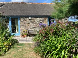 A house with a stone wall and garden at Stargazy Skies near Beacon Drive