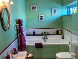 A bathroom with a bathtub and sink at Stargazy Skies near Beacon Drive, St Agnes