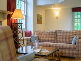 A living room with a couch and table at The School in Mungrisdale near Caldbeck