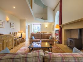 A living room with sofas and a fireplace at The School in Mungrisdale near Caldbeck