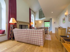 A living room with sofas and a fireplace at The School in Mungrisdale near Caldbeck