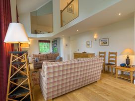 A living room with sofas and a bookshelf at The School in Mungrisdale near Caldbeck