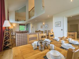 A dining room with a wooden table set for breakfast at The School in Mungrisdale near Caldbeck