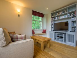 A living room with a sofa and a television at The School in Mungrisdale near Caldbeck