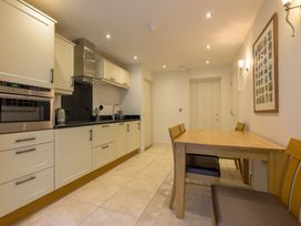A kitchen with appliances and dining table at The School in Mungrisdale near Caldbeck