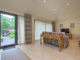 A living room with a sofa and television at The School in Mungrisdale near Caldbeck