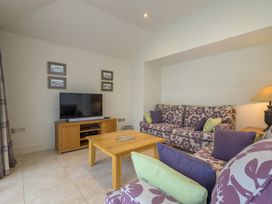 A living room with a sofa and television at The School in Mungrisdale near Caldbeck