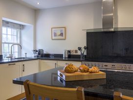 A kitchen with a black countertop and baked goods at The School in Mungrisdale near Caldbeck
