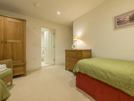 A bedroom with a wardrobe and a bed at The School in Mungrisdale near Caldbeck