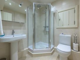 A bathroom with a shower, toilet, and sink at The School in Mungrisdale near Caldbeck