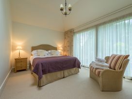 A bedroom with a bed and a chair at The School in Mungrisdale near Caldbeck