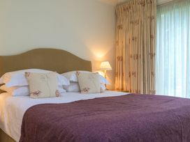 A bedroom with a bed and curtains at The School in Mungrisdale near Caldbeck