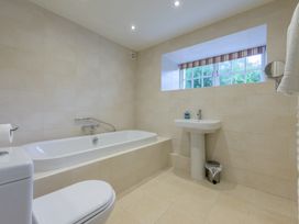 A bathroom with a bath tub and sink at The School in Mungrisdale near Caldbeck