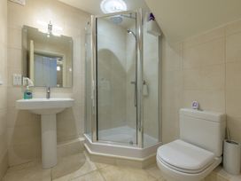 A bathroom with a shower, toilet, and sink at The School in Mungrisdale near Caldbeck