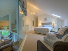 A bedroom with a bed and sitting area at The School in Mungrisdale near Caldbeck