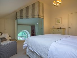 A bedroom with a bed and a window at The School in Mungrisdale near Caldbeck