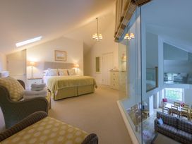 A bedroom with a bed and lamps at The School in Mungrisdale near Caldbeck
