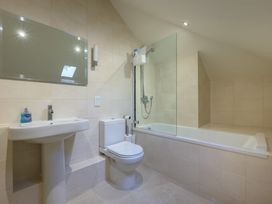 A bathroom with a sink, toilet, and bathtub at The School in Mungrisdale near Caldbeck
