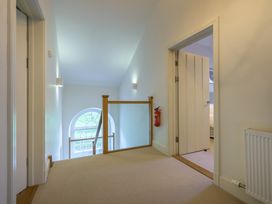 A hallway with a fire extinguisher and a door at The School in Mungrisdale near Caldbeck