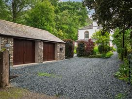 An outdoor scene featuring a garage and gravel driveway at The School in Mungrisdale near Caldbeck