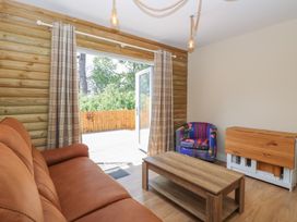 A living room with a sofa and coffee table at Barn Owl Lodge