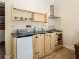 A kitchen with a sink and stove at Barn Owl Lodge
