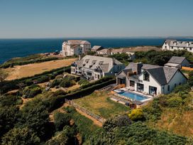 An outdoor area with houses and a swimming pool at Trevean in Mullion