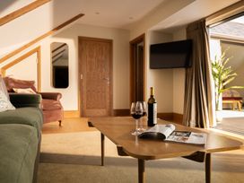A living room with a coffee table and a wine bottle at Trevean in Mullion
