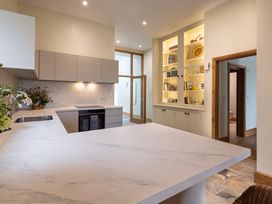 A kitchen with modern cabinetry and shelving at Trevean in Mullion