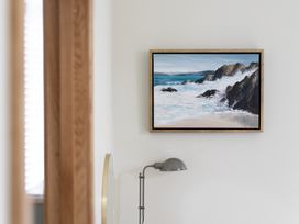 A wall painting and a lamp in a living room at Trevean in Mullion