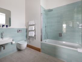 A bathroom with a sink, toilet, shower, and bathtub at Trevean in Mullion