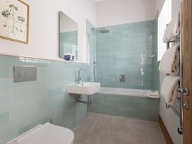 A bathroom with a shower and bathtub at Trevean in Mullion