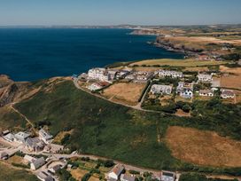 A coastal view with houses and fields at Trevean in Mullion