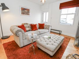 A living room with a sofa and coffee table at Fisherman’s Cottage