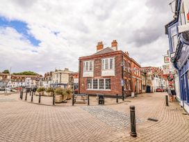 A pub building on a street with flags and lampposts at Fisherman’s Cottage in 