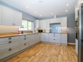 A kitchen with cabinets, sink, and countertop at Tirionfa in Talsarnau