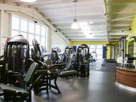 An interior view of a gym with various exercise machines and equipment at Summerdown in Brean