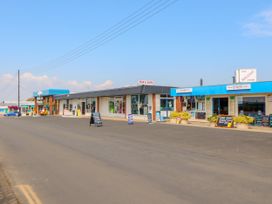 A row of shops including a fish and chips shop and a diner along a street at Sweetacres in Hemsby