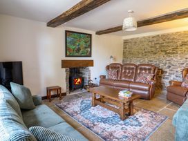 A living room with a sofa and fireplace at Upper Dolarddyn Castle Caereinion