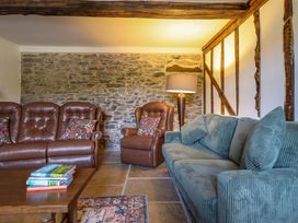 A living room with brown and green sofas at Upper Dolarddyn in Castle Caereinion