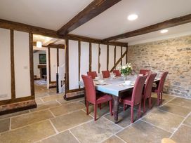 A dining room with a table and chairs at Upper Dolarddyn in Castle Caereinion