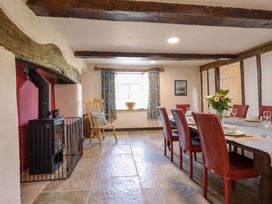 A dining room with a table and chairs at Upper Dolarddyn in Castle Caereinion
