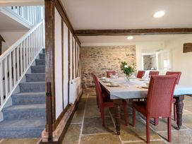 A dining room with a table and chairs at Upper Dolarddyn in Castle Caereinion