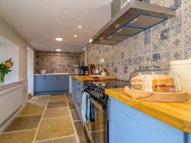 A kitchen with a stove and countertop at Upper Dolarddyn in Castle Caereinion