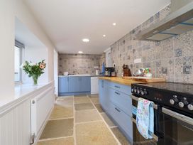 A kitchen with blue cabinets and a countertop at Upper Dolarddyn in Castle Caereinion