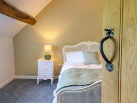 A bedroom with a bed and nightstand at Upper Dolarddyn Castle Caereinion