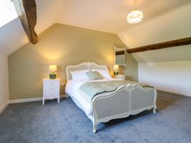 A bedroom with a bed and nightstands at Upper Dolarddyn in Castle Caereinion