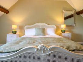 A bedroom with a bed and nightstands at Upper Dolarddyn in Castle Caereinion