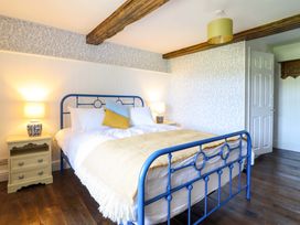 A bedroom with a bed and bedside table at Upper Dolarddyn in Castle Caereinion