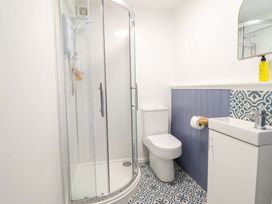 A bathroom with a shower, toilet, and sink at Upper Dolarddyn, Castle Caereinion
